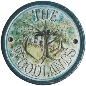 Terracotta plaque showing a woodland cottage