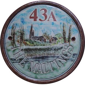 Church and river on a terracotta house plaque